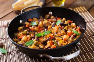 italian-caponata-with-frying-pan-wooden-table_2829-8064