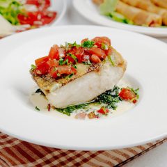 side-view-baked-seabass-with-tomatoes_141793-2616